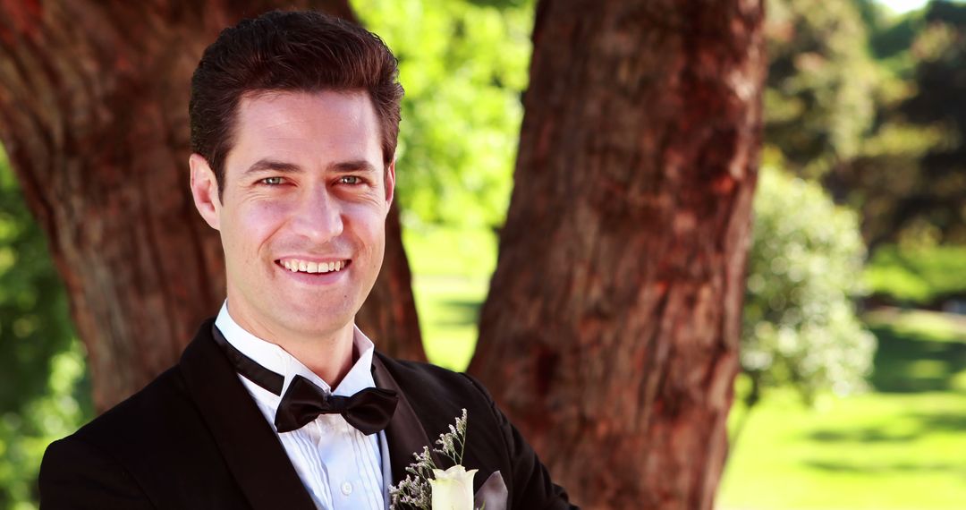 Groom Smiling Outdoors in a Black Tuxedo at Wedding - Free Images, Stock Photos and Pictures on Pikwizard.com