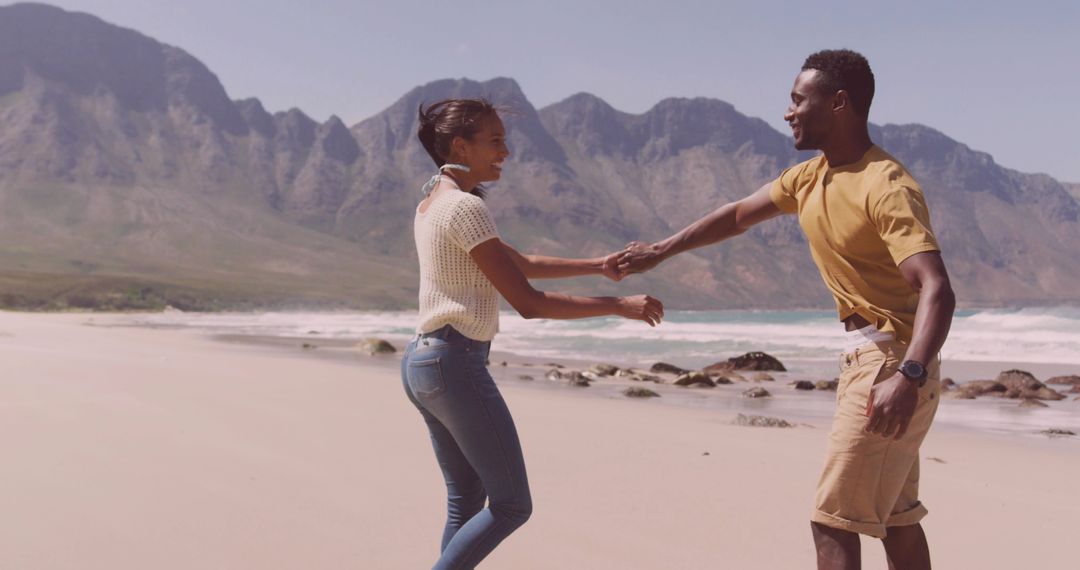Couple Enjoying Romantic Beach Adventure by Scenic Mountains