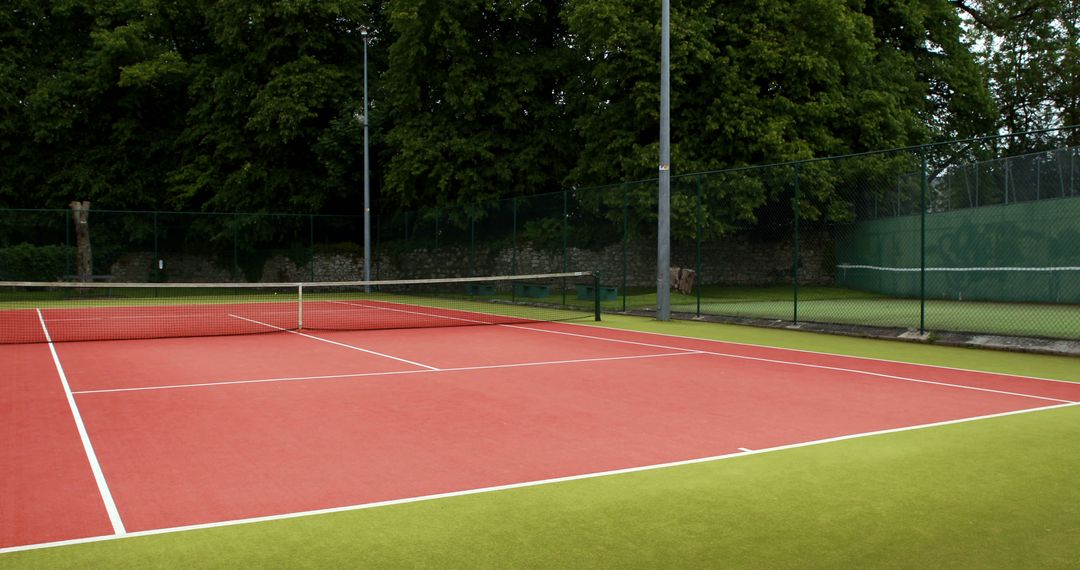 Sunny Day Red and Green Tennis Court - Free Images, Stock Photos and Pictures on Pikwizard.com