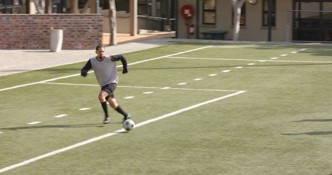 Dynamic Youth Soccer Player Dribbling Ball on Field