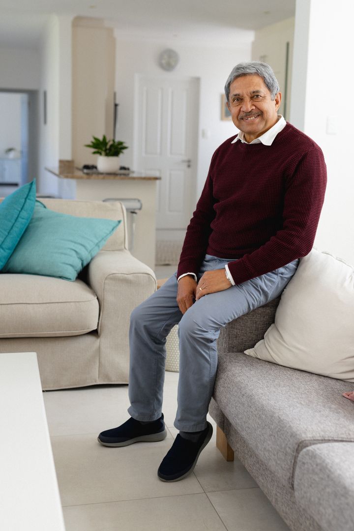 Happy Senior Man Smiling in Cozy Living Room - Free Images, Stock Photos and Pictures on Pikwizard.com