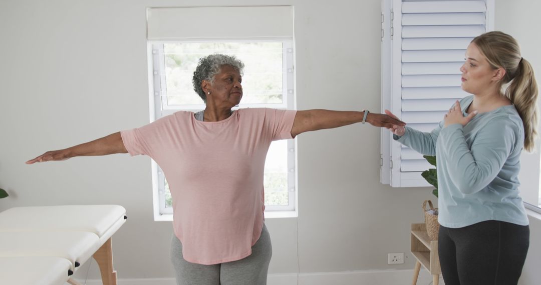 Elderly Woman Exercising with Physical Therapist at Home - Free Images, Stock Photos and Pictures on Pikwizard.com