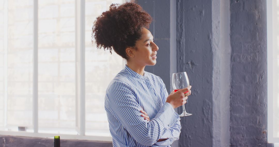 Businesswoman Relaxing with a Beverage by Office Window