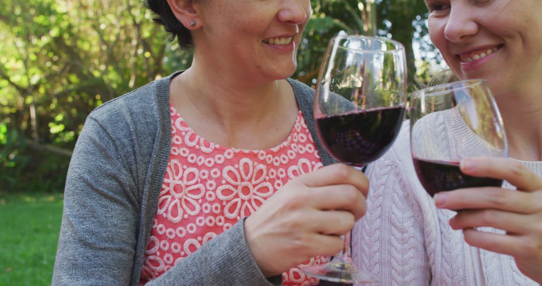 Two Women Enjoying Red Wine Outdoors - Free Images, Stock Photos and Pictures on Pikwizard.com