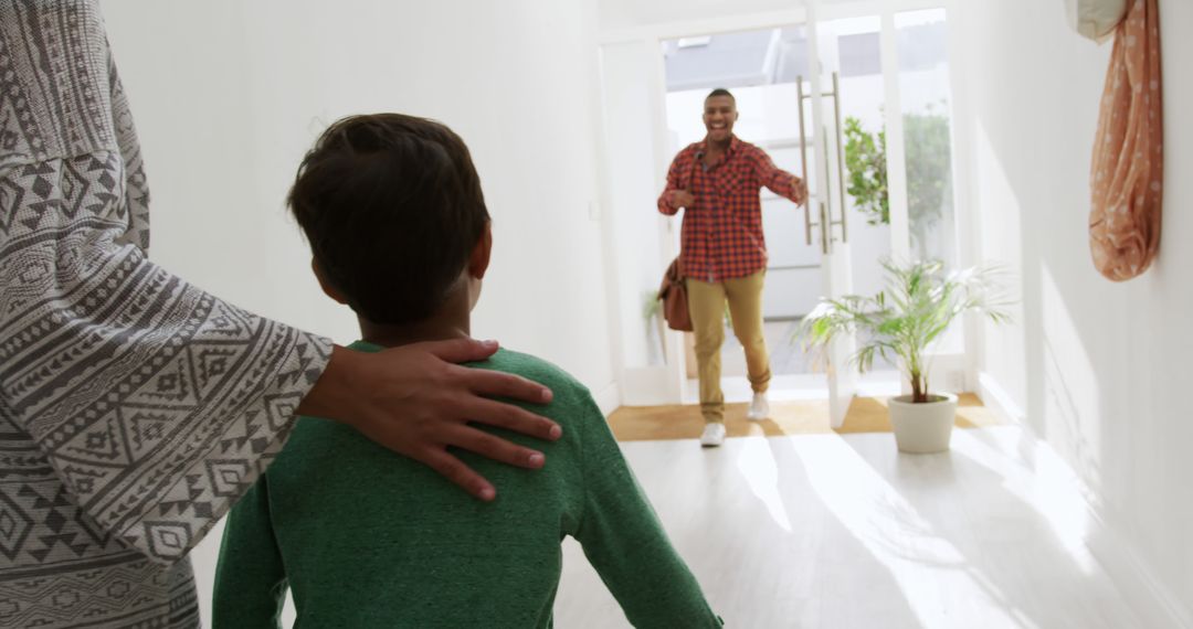 Child excitedly greeting returning parent at home - Free Images, Stock Photos and Pictures on Pikwizard.com