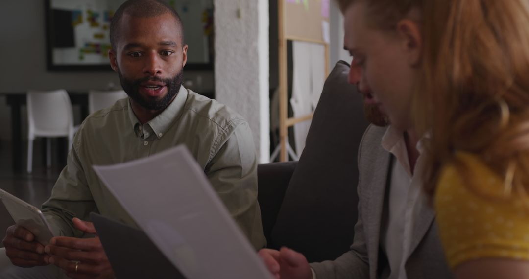 Creative Team Discussing Project in Modern Office Space