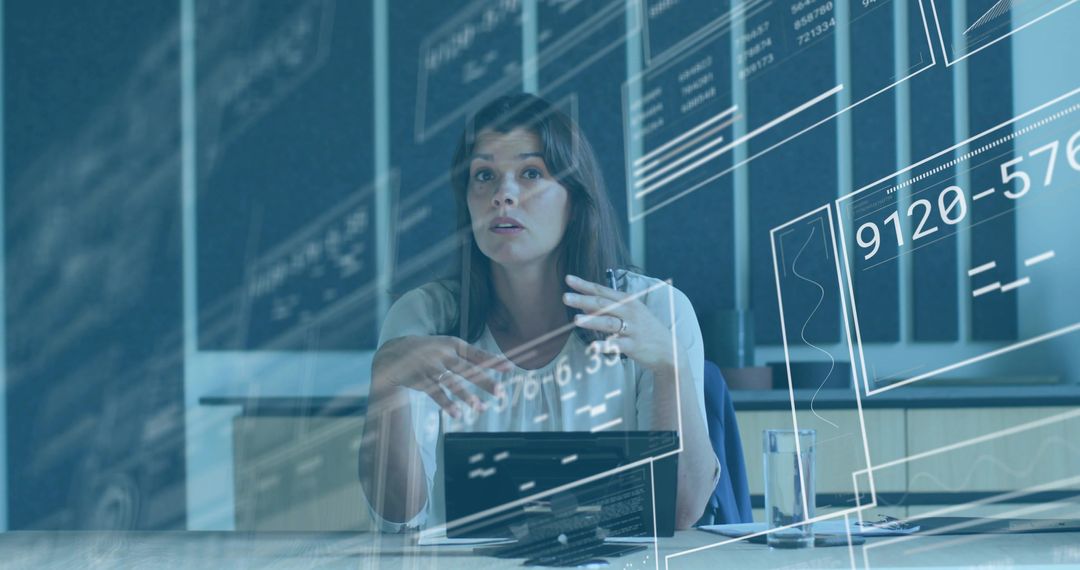Midadult woman presenting analytics with tablet and translucent UI overlays in office