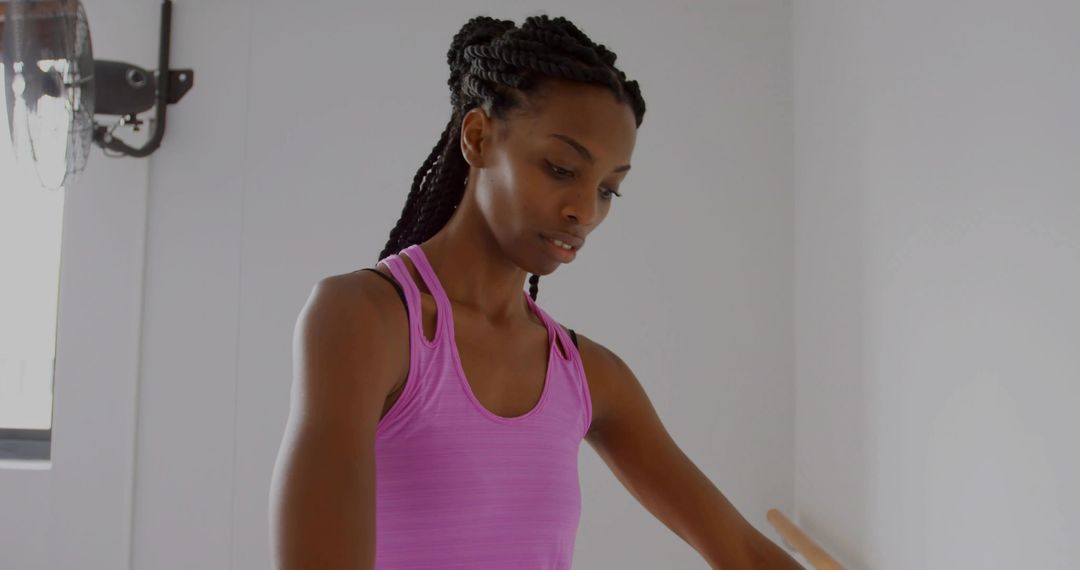 Graceful Ballerina Practicing Dance Movements in Studio