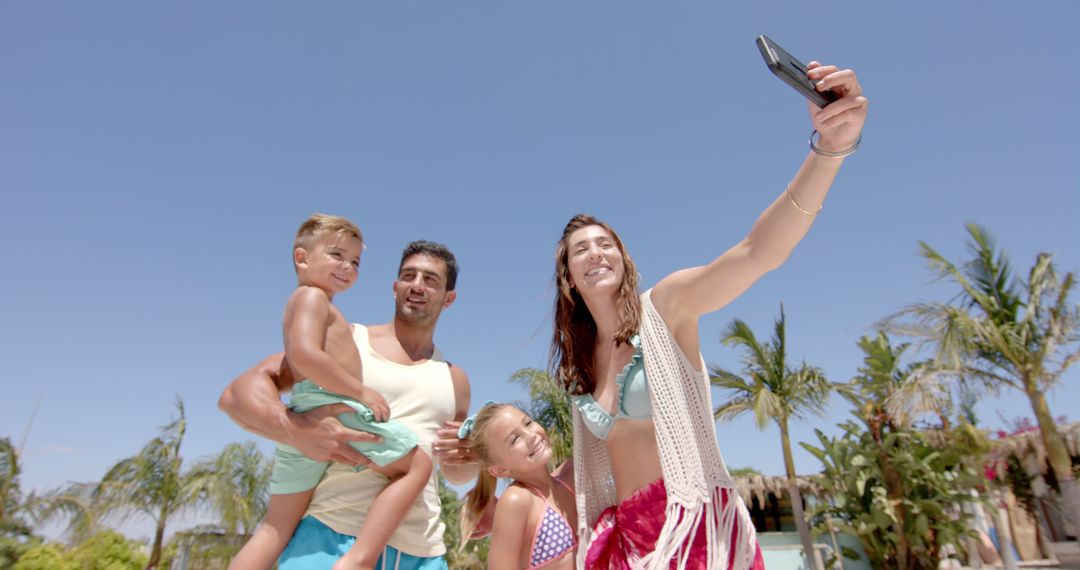 Smiling Family Taking Selfie at Tropical Beach Resort - Free Images, Stock Photos and Pictures on Pikwizard.com