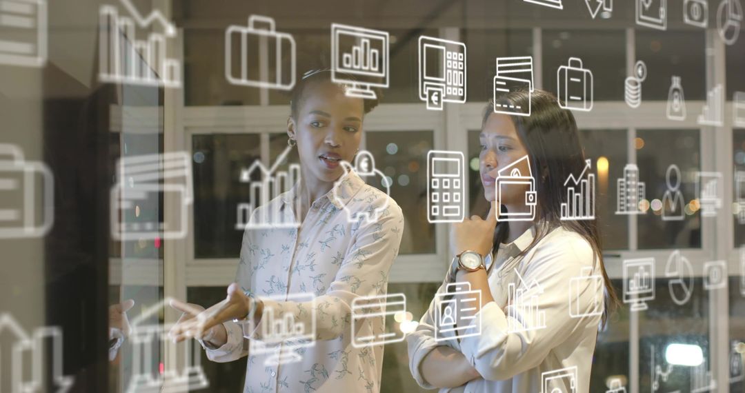 Diverse Businesswomen Discussing Data Through Digital Interface