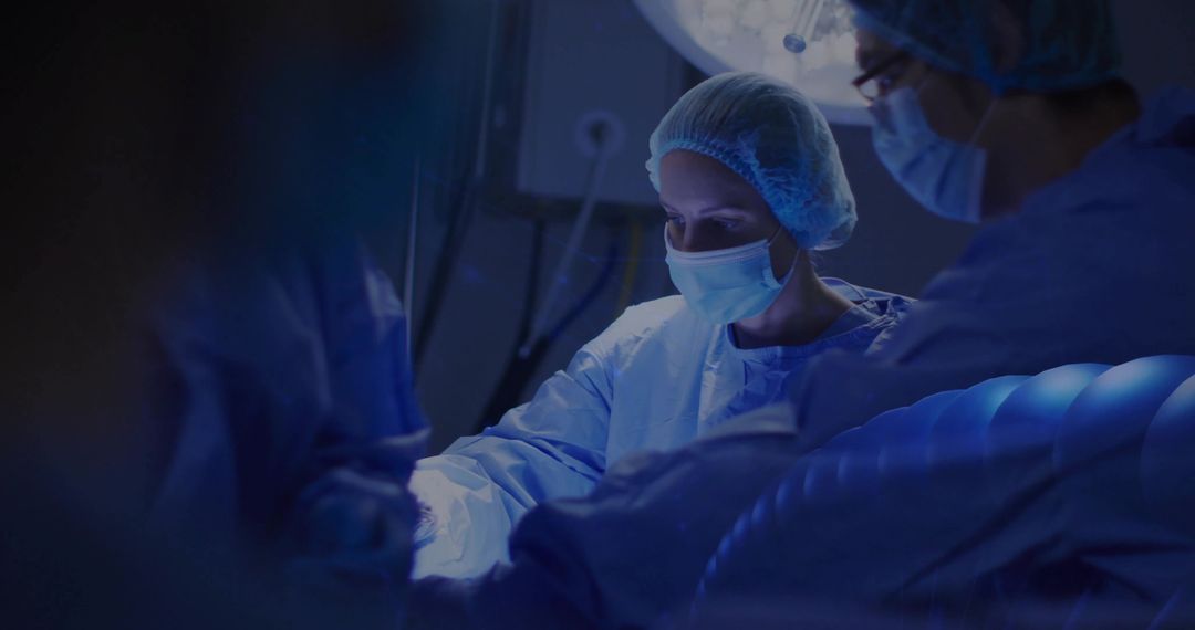 Surgeons Performing Delicate Operation Under Surgical Light