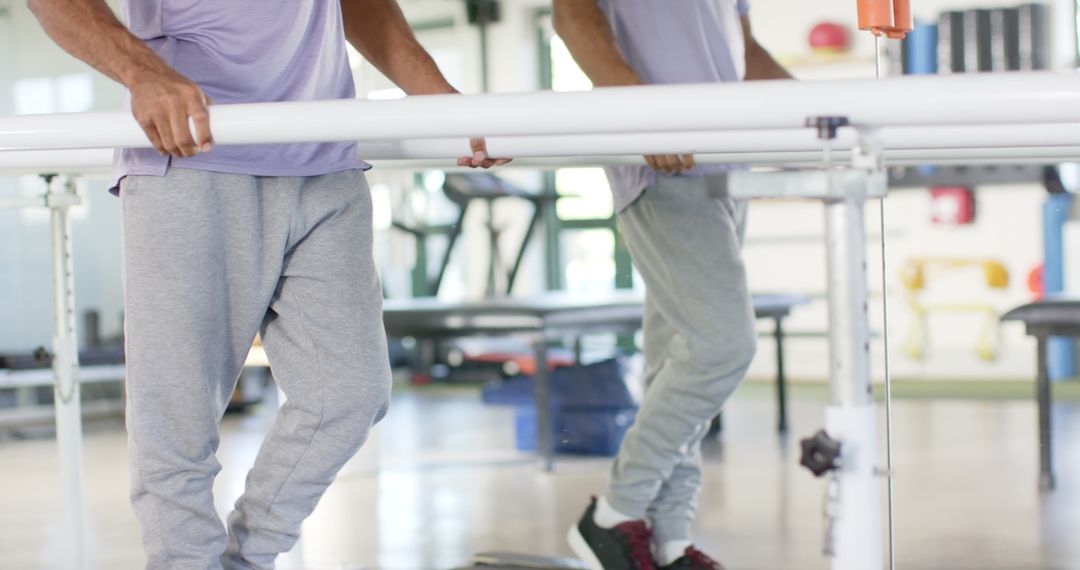 Man Recovering Mobility with Physiotherapy at Rehabilitation Center