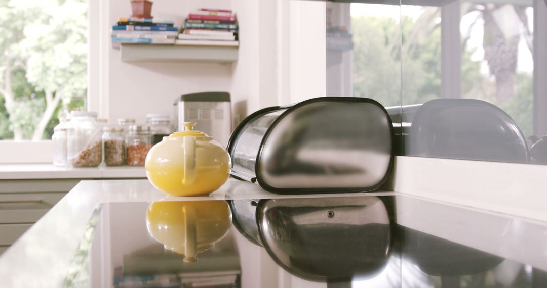 Contemporary Kitchen Counter with Yellow Teapot and Bookshelf - Free Images, Stock Photos and Pictures on Pikwizard.com