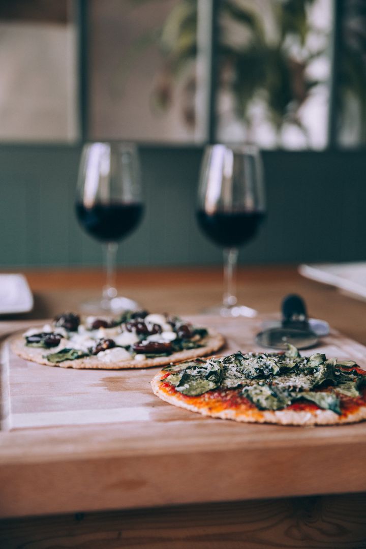 Gourmet Vegetarian Pizza Pairing with Red Wine on Rustic Table