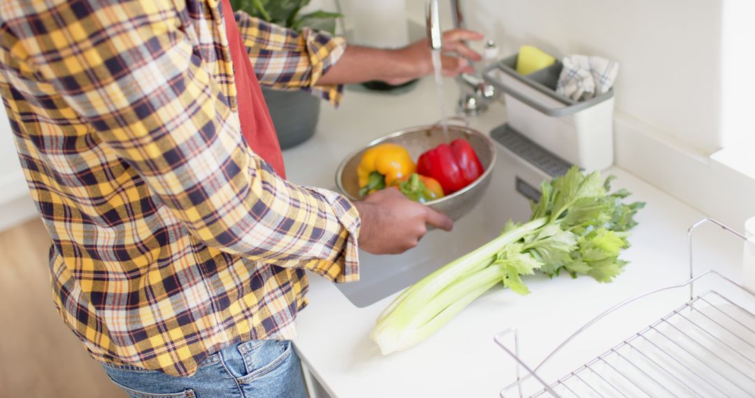 Person Washing Fresh Vegetables in Modern Kitchen - Free Images, Stock Photos and Pictures on Pikwizard.com