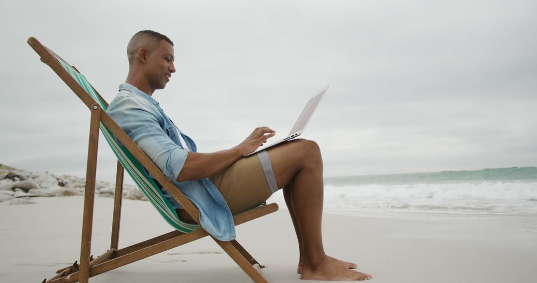 Man Relaxing on Beach While Working on Laptop - Free Images, Stock Photos and Pictures on Pikwizard.com