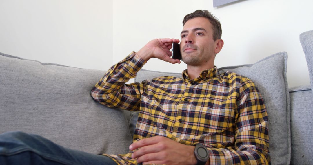 Man Talking on Smartphone at Home - Free Images, Stock Photos and Pictures on Pikwizard.com