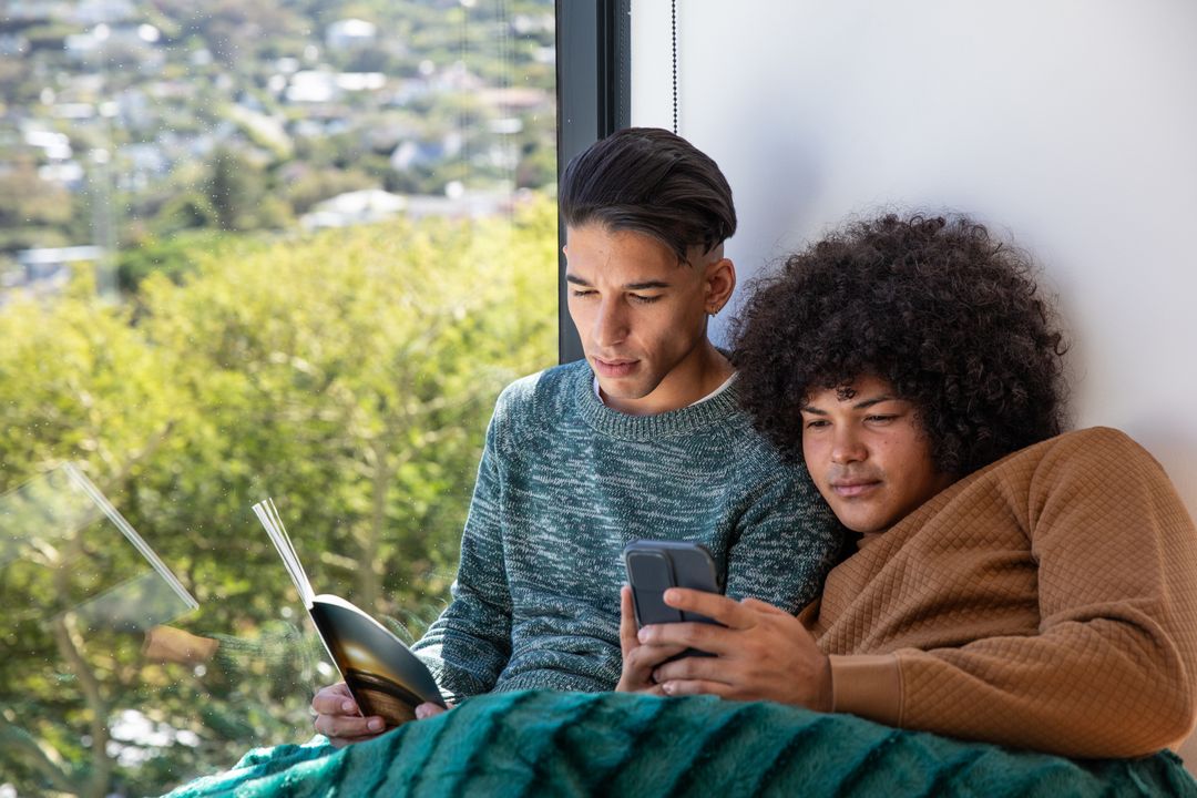 Casual Friends Reading and Relaxing by Window