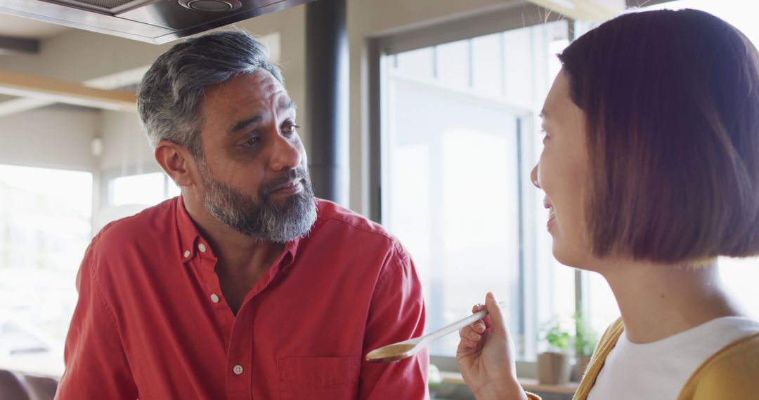 Diverse Couple Enjoys Cooking Together in Kitchen