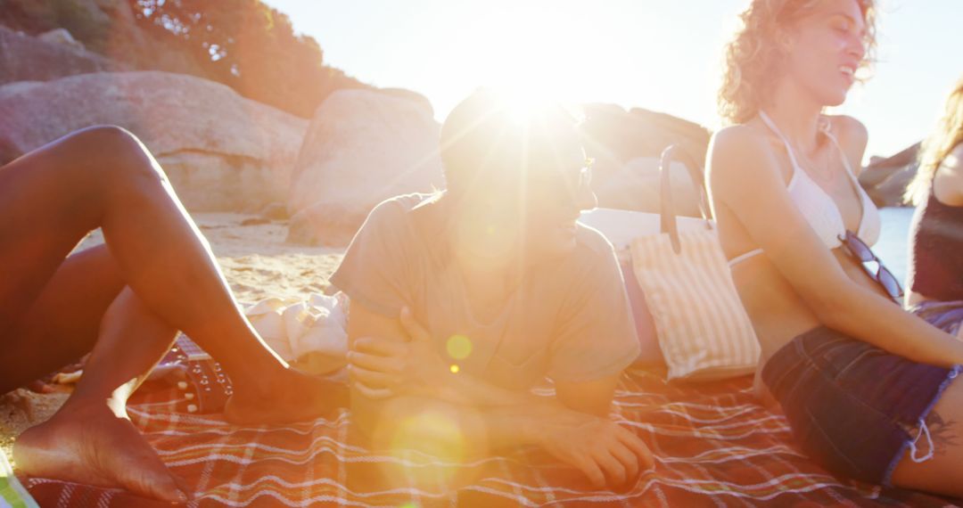 Friends Relaxing on Beach Blanket at Sunset - Free Images, Stock Photos and Pictures on Pikwizard.com