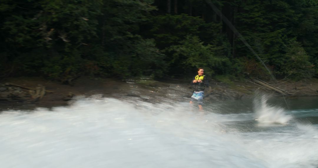 Man Wakeboarding on Lake Amid Lush Forest - Free Images, Stock Photos and Pictures on Pikwizard.com