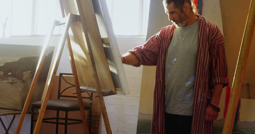 Male Artist Painting on Canvas in Sunlit Studio - Free Images, Stock Photos and Pictures on Pikwizard.com