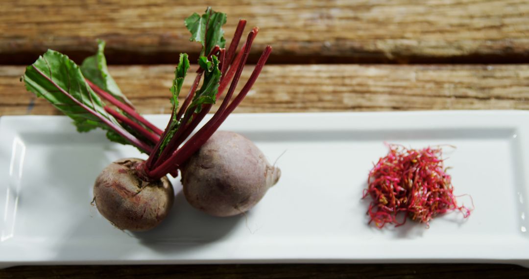 Fresh Beetroots with Greens and Shredded Beet Strands on Wooden Table - Free Images, Stock Photos and Pictures on Pikwizard.com