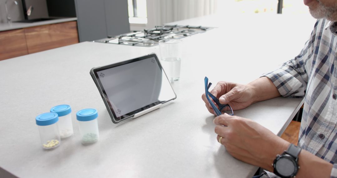 Senior Man Measures Blood Pressure with Tablet Health Monitor - Free Images, Stock Photos and Pictures on Pikwizard.com