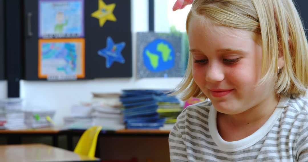 Young Girl Smiling While Using Tablet in Classroom