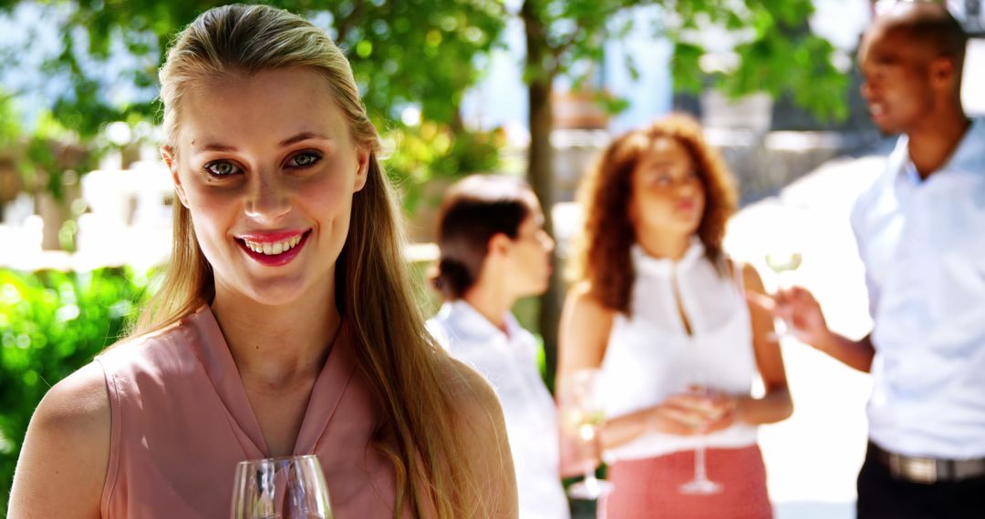 Smiling Woman Enjoying Outdoor Social Event with Friends - Free Images, Stock Photos and Pictures on Pikwizard.com