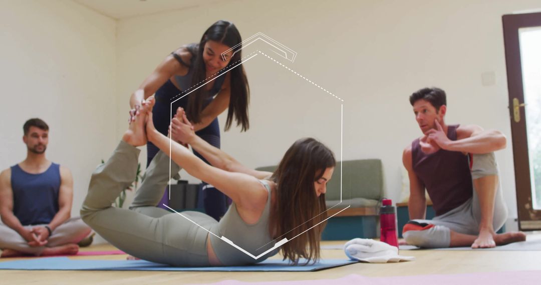 Instructor Assisting Yoga Student in Bow Pose at Bright Studio