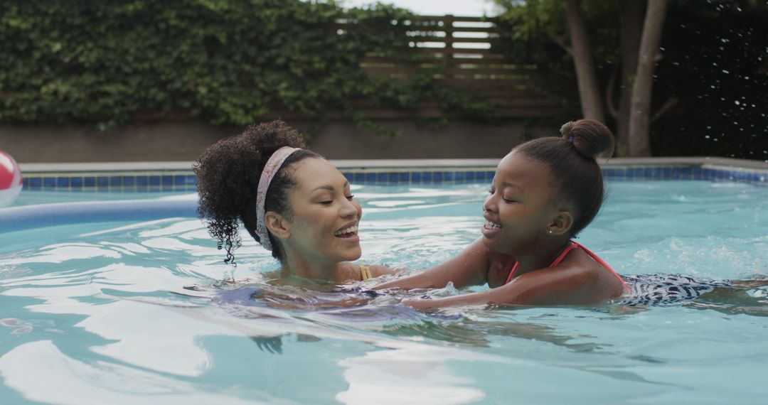 Mother and Daughter Enjoying Swim in Backyard Pool - Free Images, Stock Photos and Pictures on Pikwizard.com