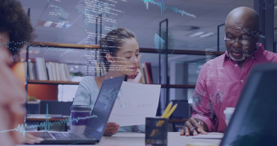 Business Team Analyzing Data in Modern Office with Laptops