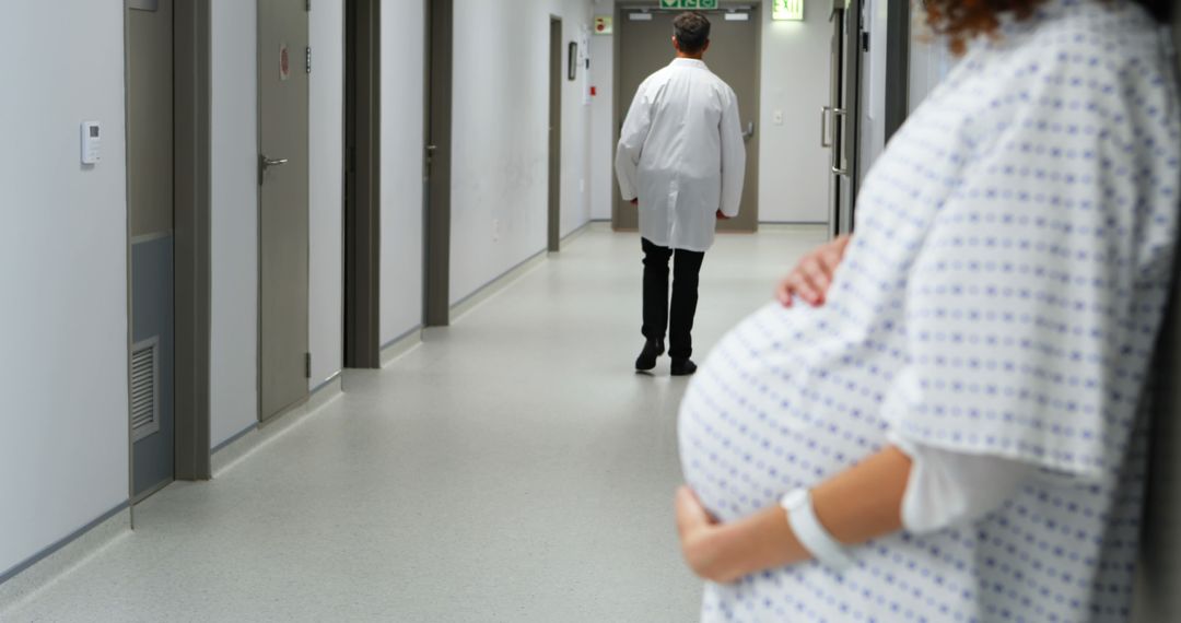 Pregnant Woman Awaiting in Hospital Corridor with Doctor Walking Away - Free Images, Stock Photos and Pictures on Pikwizard.com