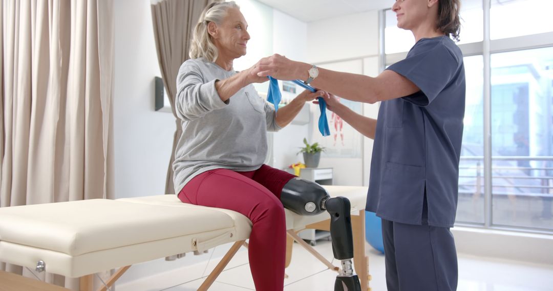 Physiotherapist Helping Female Amputee with Prosthetic Leg in Rehabilitation Center - Free Images, Stock Photos and Pictures on Pikwizard.com