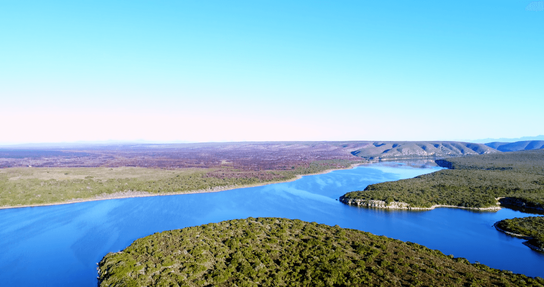 Transparent Clear Sky Over Tranquil Sea and Green Landscapes