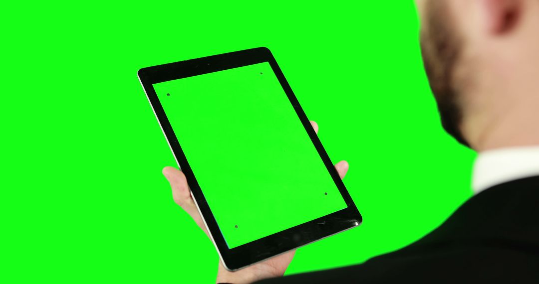 Businessman Holding Tablet with Green Screen - Free Images, Stock Photos and Pictures on Pikwizard.com