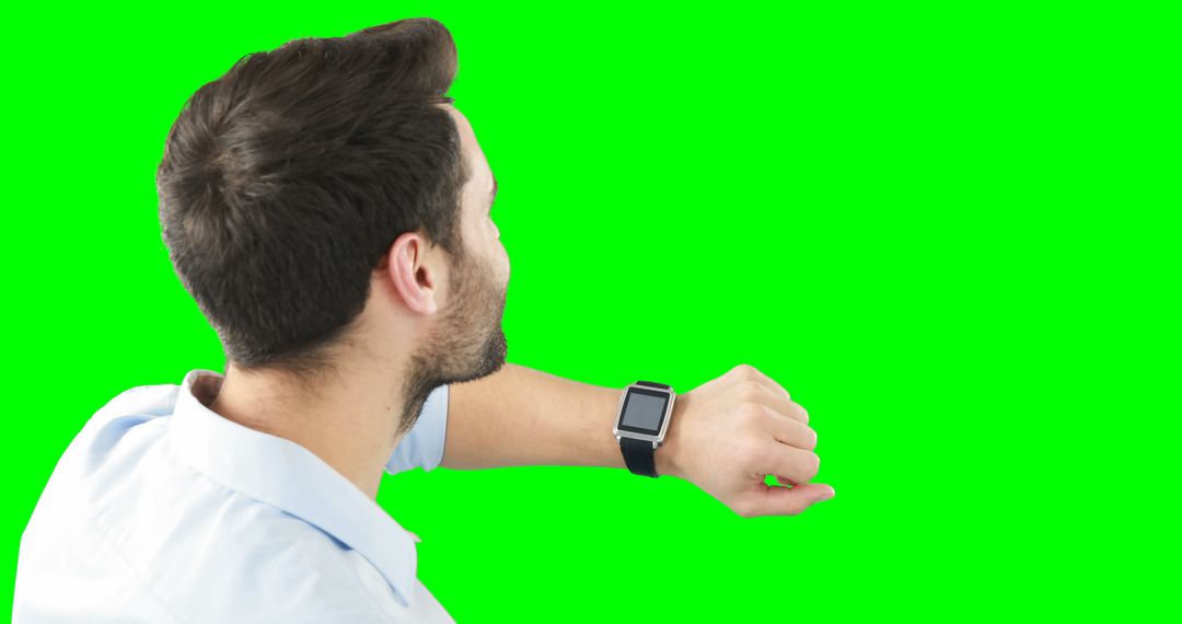 Man Checking Smartwatch with Green Background - Free Images, Stock Photos and Pictures on Pikwizard.com