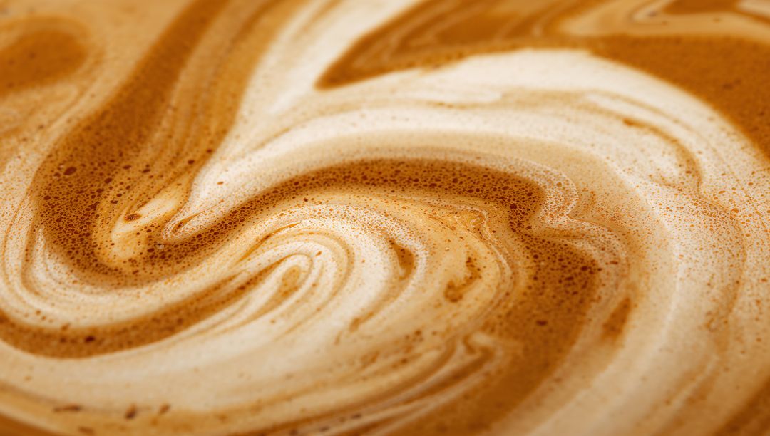 Swirling Coffee with Marbled Foam Patterns in Close-Up View