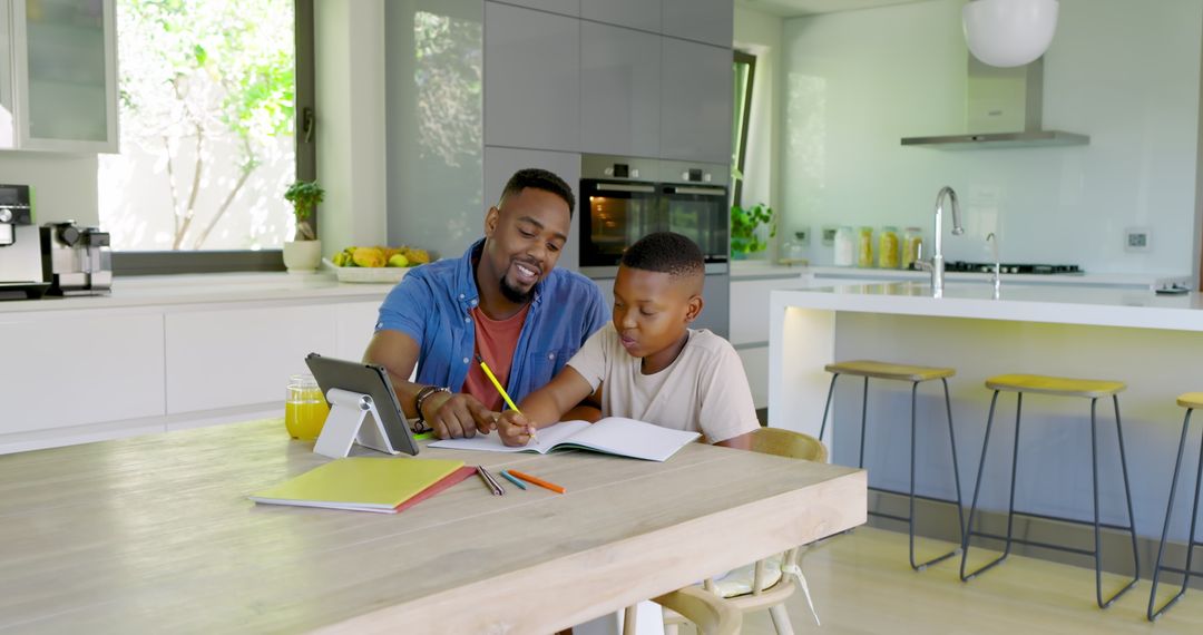 Father Guiding Son with Schoolwork at Kitchen Table in Bright Home