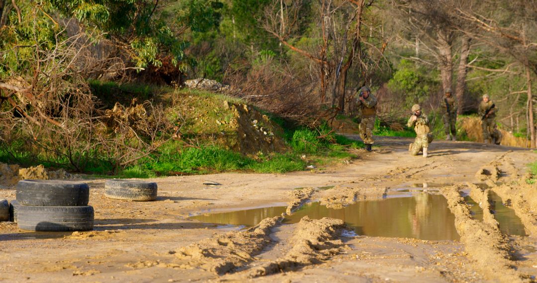 Soldiers Patrolling Muddy Road in Forest - Free Images, Stock Photos and Pictures on Pikwizard.com