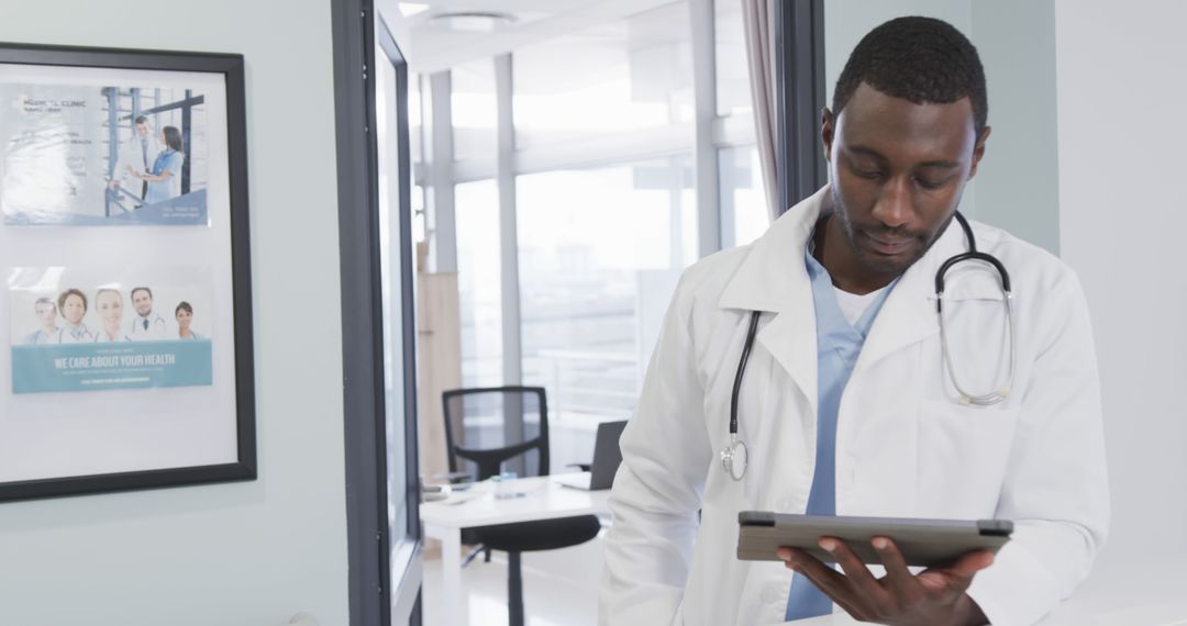 Confident Doctor Reviewing Patient Records on Digital Tablet in Medical Office - Free Images, Stock Photos and Pictures on Pikwizard.com