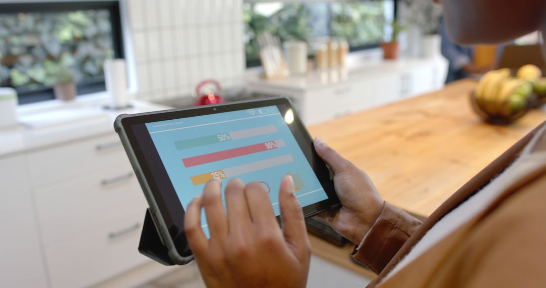 Person Analyzing Data on Digital Tablet in Modern Kitchen - Free Images, Stock Photos and Pictures on Pikwizard.com