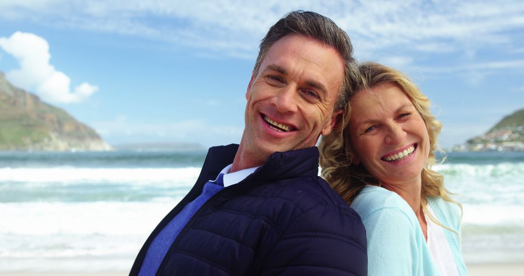 Smiling Middle-aged Couple Enjoying Beach Vacation on Sunny Day - Free Images, Stock Photos and Pictures on Pikwizard.com