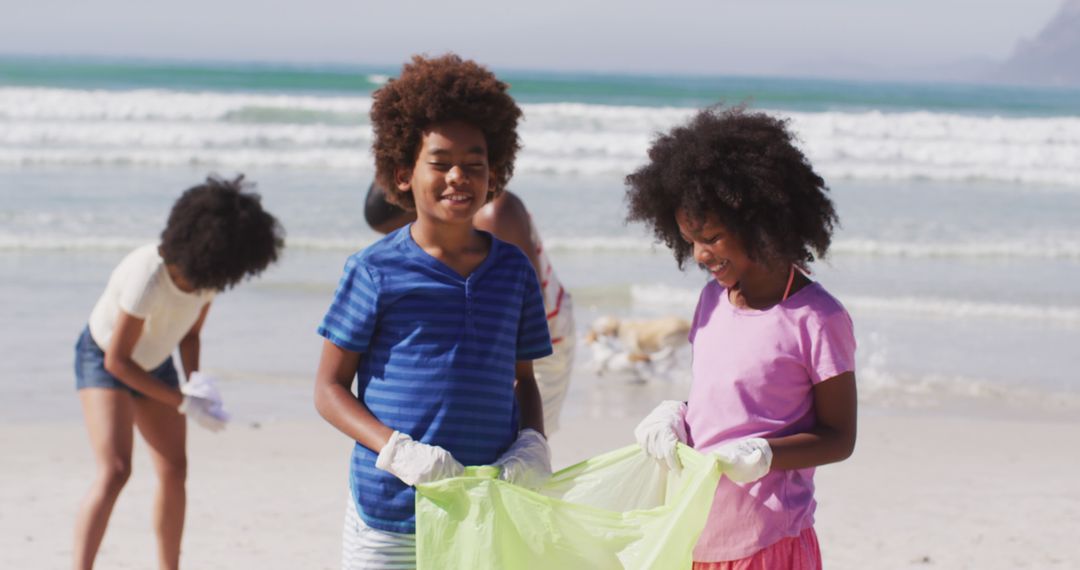 Children Collecting Trash During Beach Cleanup Event - Free Images, Stock Photos and Pictures on Pikwizard.com