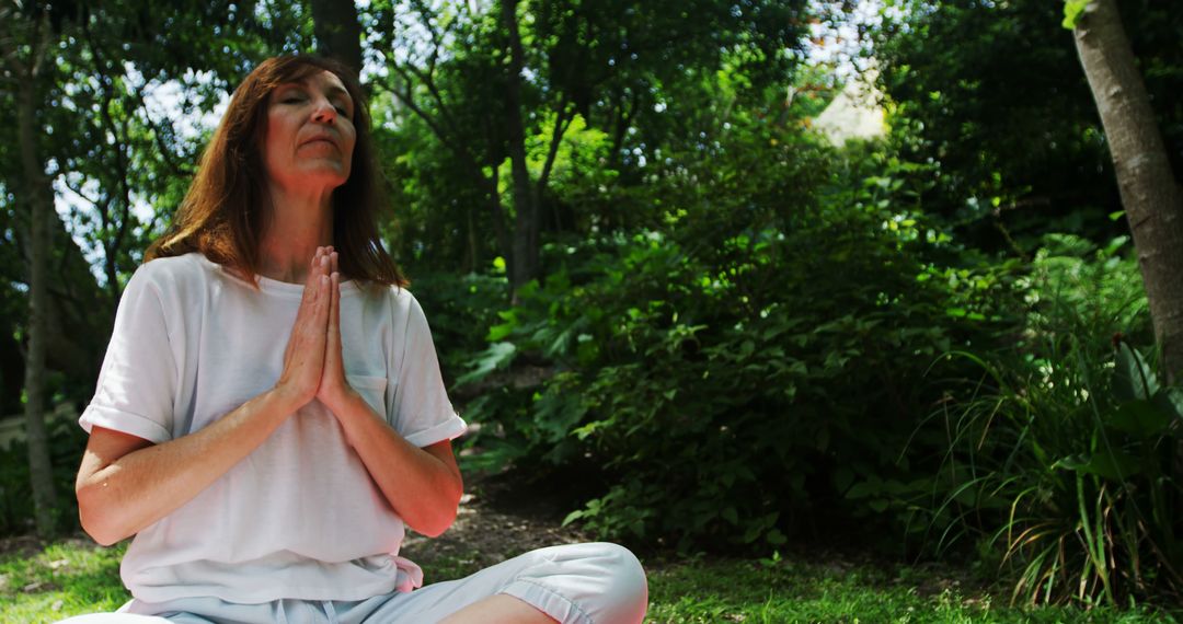 Mature Woman Practicing Meditation in Tranquil Forest Setting - Free Images, Stock Photos and Pictures on Pikwizard.com