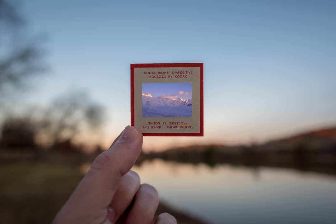 Holding Vintage Photo Slide with Mountain Landscape at Sunset - Free Images, Stock Photos and Pictures on Pikwizard.com