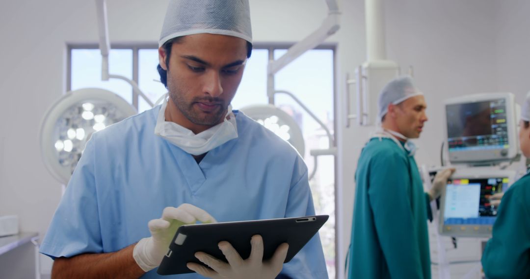 Surgeons Using Digital Tablet in Operating Room - Free Images, Stock Photos and Pictures on Pikwizard.com