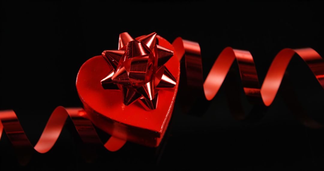 Red Heart-shaped Gift with Ribbon and Bow on Black Background - Free Images, Stock Photos and Pictures on Pikwizard.com