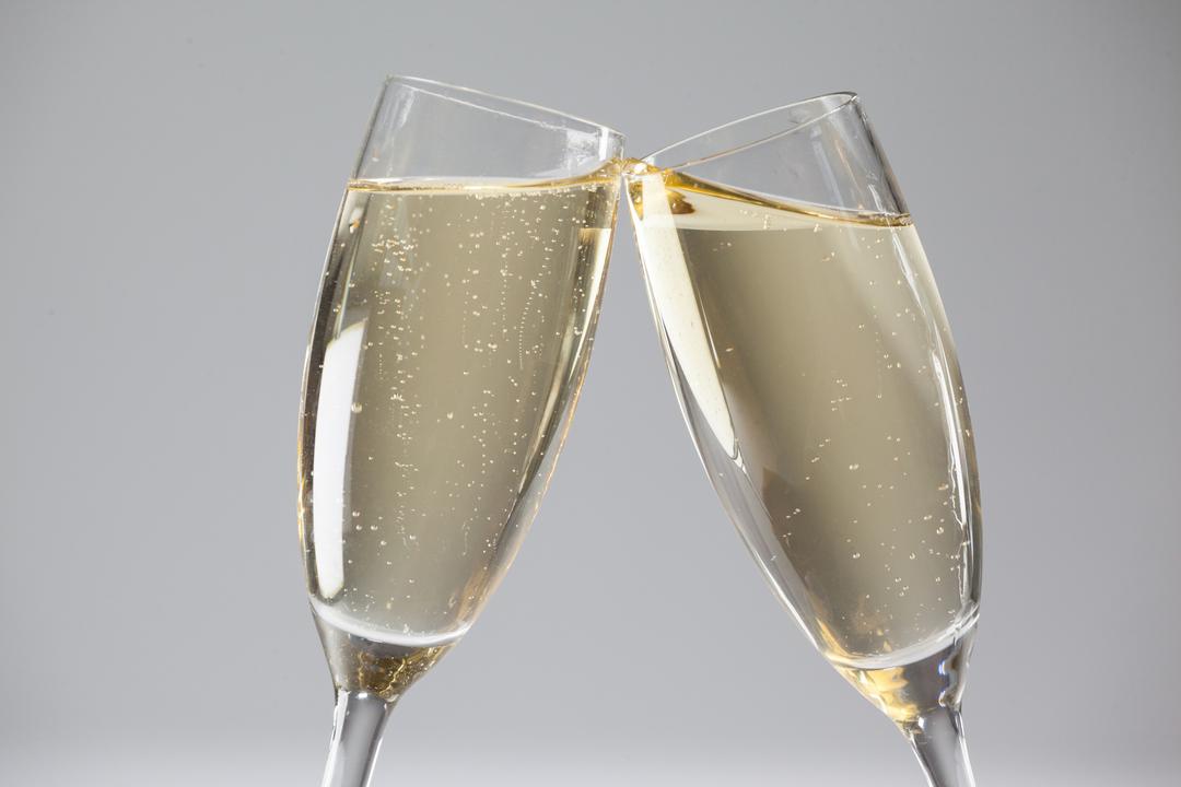 Two champagne flutes on white background - Free Images, Stock Photos and Pictures on Pikwizard.com